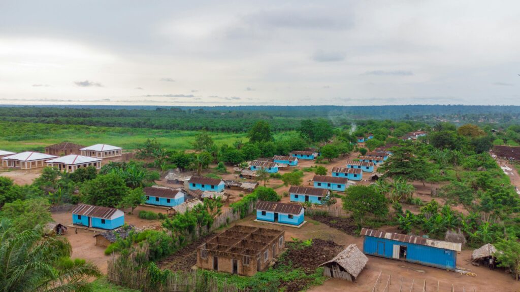 Aerial shot capturing the rural village landscape in DR Congo's lush green environment.